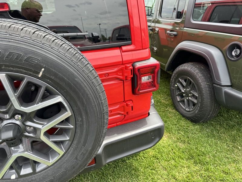 2024 Jeep Wrangler 4-door Sahara in a Firecracker Red Clear Coat exterior color. Gupton Motors Inc 615-384-2886 guptonmotors.com 