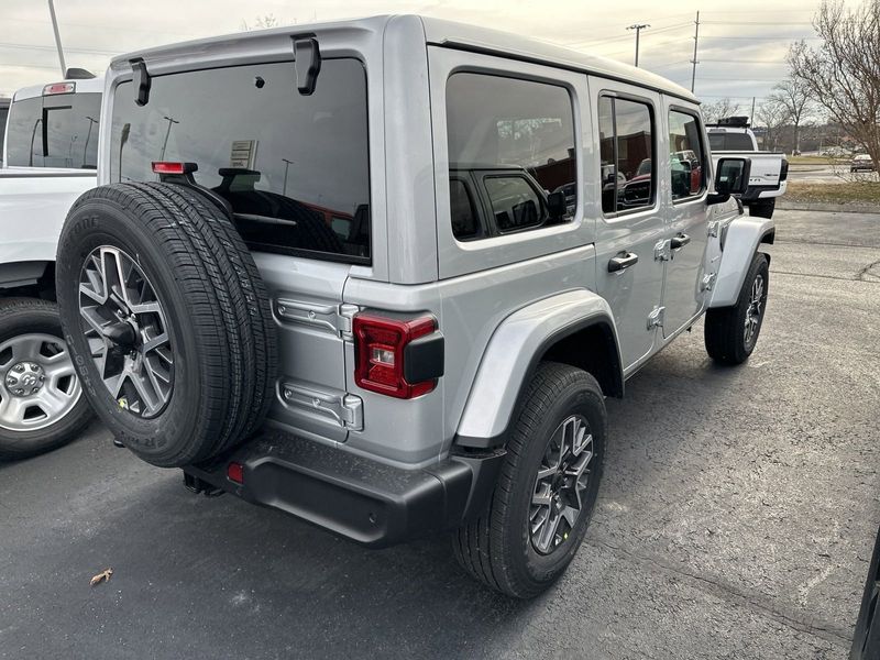 2024 Jeep Wrangler 4-door Sahara in a Silver Zynith Clear Coat exterior color and Blackinterior. CDJR of Anytown 949-555-4321 pixelmotiondemo.com 