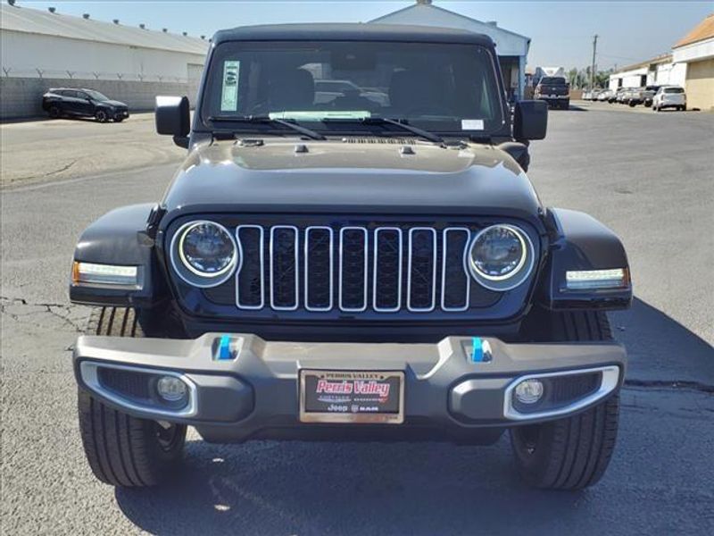 2024 Jeep Wrangler Sahara 4xe in a Black Clear Coat exterior color and Blackinterior. Perris Valley Auto Center 951-657-6100 perrisvalleyautocenter.com 