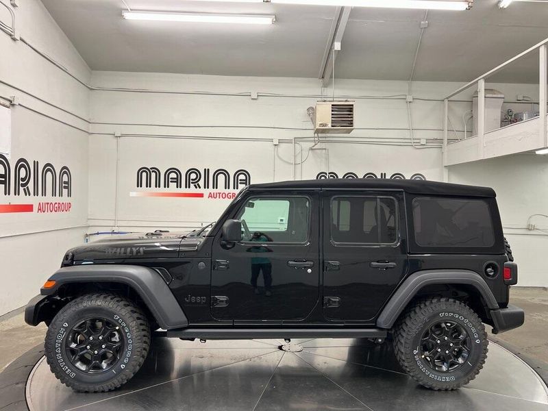 2023 Jeep Wrangler 4-door Willys 4x4 in a Black Clear Coat exterior color and Blackinterior. Marina Chrysler Dodge Jeep RAM (855) 616-8084 marinadodgeny.com 