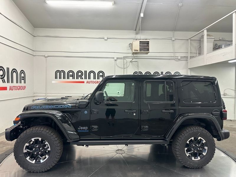 2024 Jeep Wrangler 4-door Rubicon X 4xe in a Black Clear Coat exterior color and Blackinterior. Marina Auto Group (855) 564-8688 marinaautogroup.com 