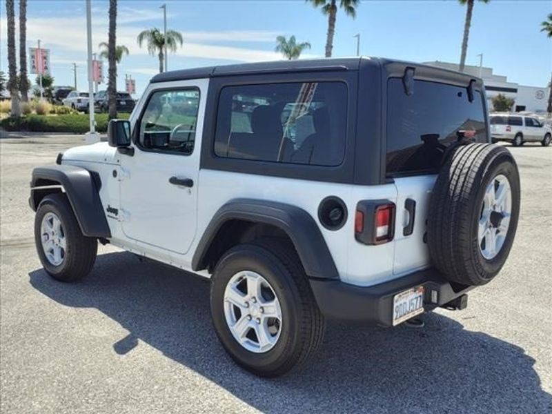 2022 Jeep Wrangler Sport S in a Bright White Clear Coat exterior color and Blackinterior. Perris Valley Auto Center 951-657-6100 perrisvalleyautocenter.com 