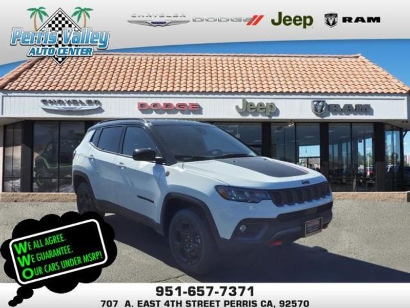 2024 Jeep Compass Trailhawk in a Bright White Clear Coat exterior color and Ruby Red/Blackinterior. Perris Valley Auto Center 951-657-6100 perrisvalleyautocenter.com 