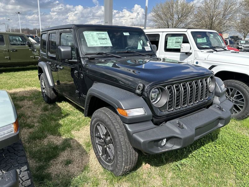 2024 Jeep Wrangler 4-door Sport S in a Black Clear Coat exterior color and Blackinterior. CDJR of Anytown 949-555-4321 pixelmotiondemo.com 