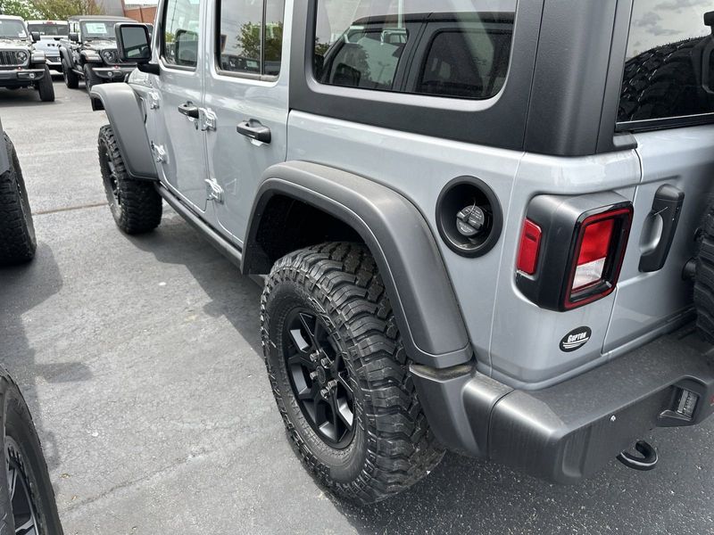 2024 Jeep Wrangler 4-door Willys in a Silver Zynith Clear Coat exterior color and Blackinterior. CDJR of Anytown 949-555-4321 pixelmotiondemo.com 