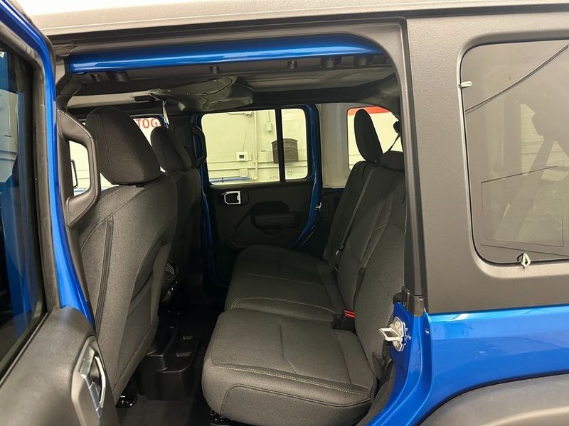 2024 Jeep Wrangler 4-door Willys 4xe in a Hydro Blue Pearl Coat exterior color and Blackinterior. Marina Chrysler Dodge Jeep RAM (855) 616-8084 marinadodgeny.com 