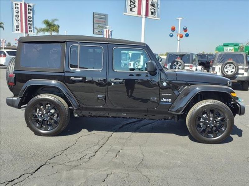 2024 Jeep Wrangler Sahara 4xe in a Black Clear Coat exterior color and Blackinterior. Perris Valley Auto Center 951-657-6100 perrisvalleyautocenter.com 