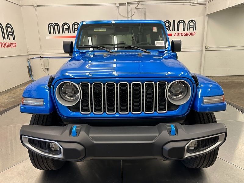 2024 Jeep Wrangler 4-door Sahara 4xe in a Hydro Blue Pearl Coat exterior color and Blackinterior. Marina Chrysler Dodge Jeep RAM (855) 616-8084 marinadodgeny.com 