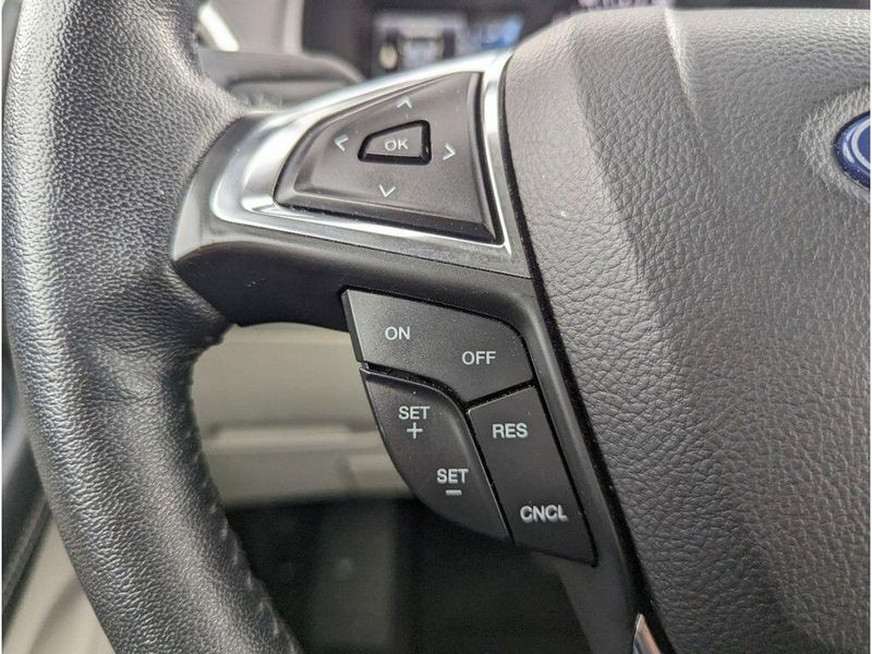2022 Ford Edge Titanium in a Carbonized Gray Metallic exterior color and Medium Soft Ceramicinterior. Johnson Dodge 601-693-6343 pixelmotiondemo.com 