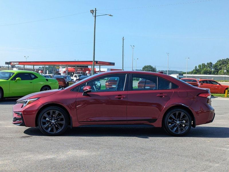 2023 Toyota Corolla SE in a Ruby Flare Pearl exterior color and Black/Redinterior. Johnson Dodge 601-693-6343 pixelmotiondemo.com 