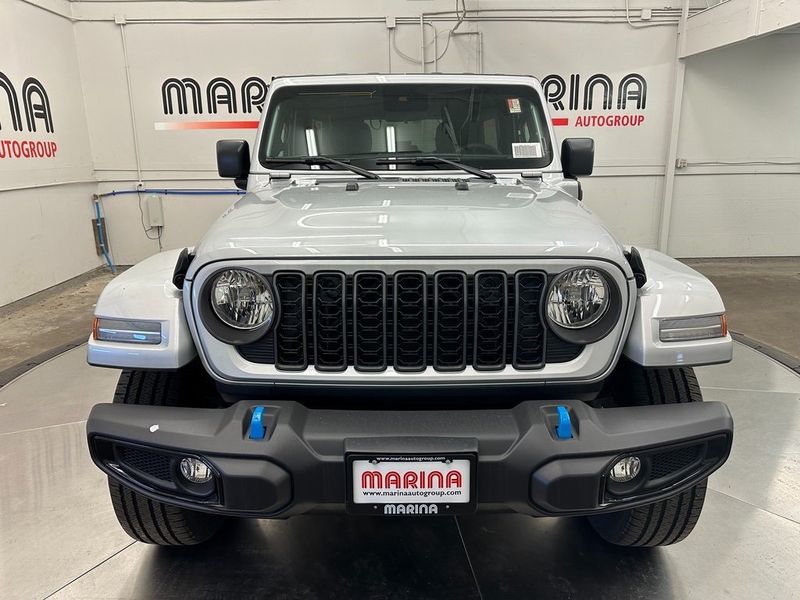 2024 Jeep Wrangler 4-door Sport S 4xe in a Silver Zynith Clear Coat exterior color and Blackinterior. Marina Auto Group (855) 564-8688 marinaautogroup.com 