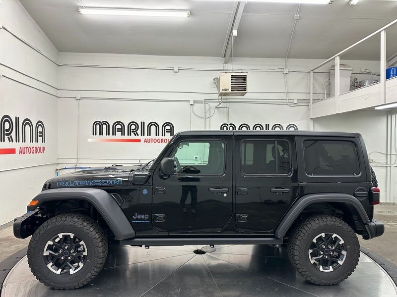 2024 Jeep Wrangler 4-door Rubicon 4xe in a Black Clear Coat exterior color and Blackinterior. Marina Auto Group (855) 564-8688 marinaautogroup.com 