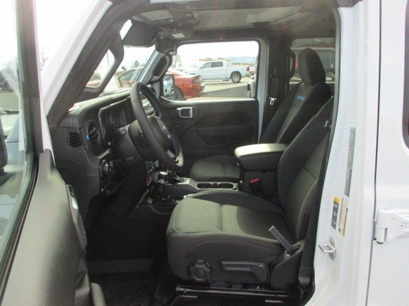 2024 Jeep Wrangler 4-door Rubicon 4xe in a Bright White Clear Coat exterior color. Oak Harbor Motors Inc. 360-323-6434 ohmotors.com 