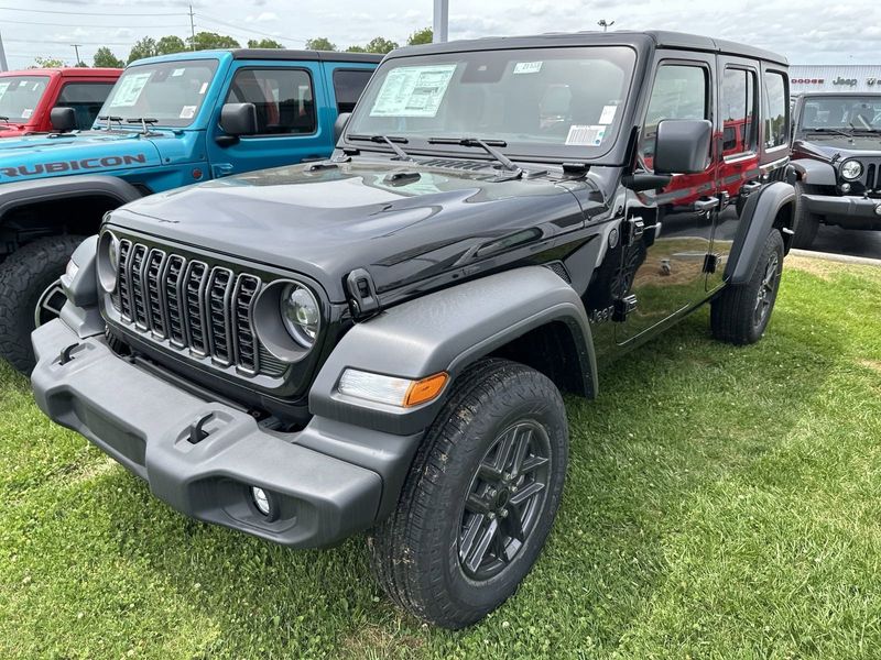 2024 Jeep Wrangler 4-door Sport S in a Black Clear Coat exterior color and Blackinterior. CDJR of Anytown 949-555-4321 pixelmotiondemo.com 