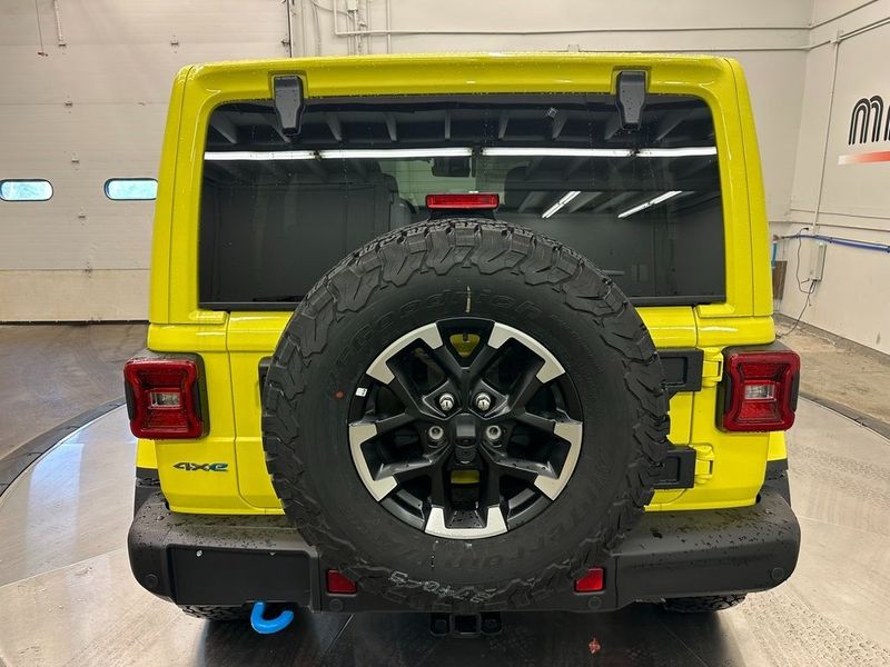 2024 Jeep Wrangler 4-door Rubicon X 4xe in a High Velocity Clear Coat exterior color and Blackinterior. Marina Chrysler Dodge Jeep RAM (855) 616-8084 marinadodgeny.com 