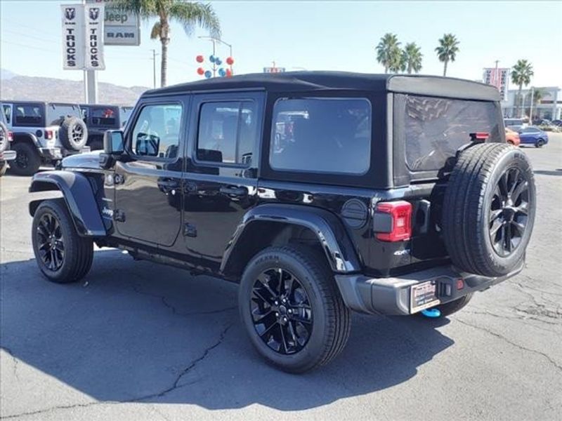 2024 Jeep Wrangler Sahara 4xe in a Black Clear Coat exterior color and Blackinterior. Perris Valley Auto Center 951-657-6100 perrisvalleyautocenter.com 