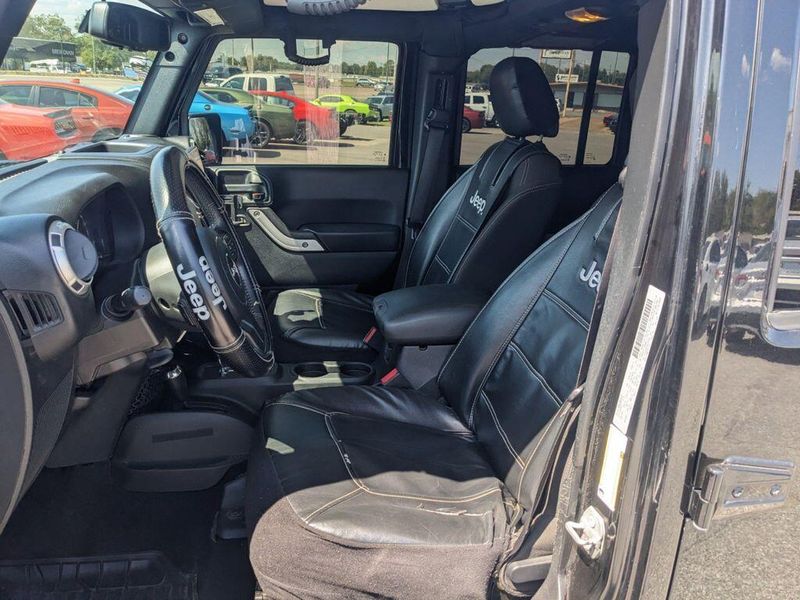 2017 Jeep Wrangler Unlimited Sahara in a Black Clear Coat exterior color and Blackinterior. Johnson Dodge 601-693-6343 pixelmotiondemo.com 