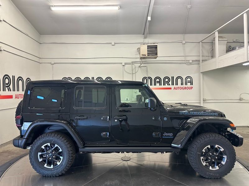 2024 Jeep Wrangler 4-door Rubicon X 4xe in a Black Clear Coat exterior color and Blackinterior. Marina Auto Group (855) 564-8688 marinaautogroup.com 