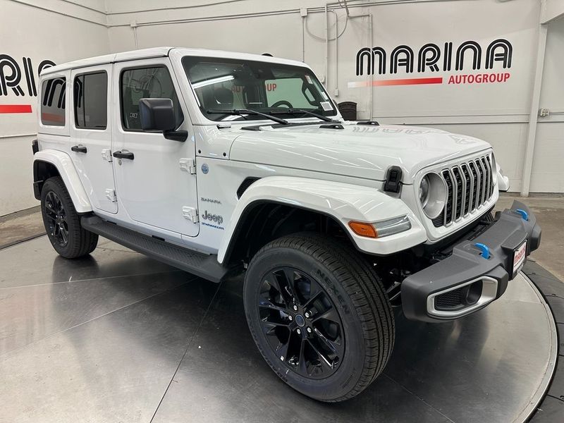 2024 Jeep Wrangler 4-door Sahara 4xe in a Bright White Clear Coat exterior color. Marina Auto Group (855) 564-8688 marinaautogroup.com 