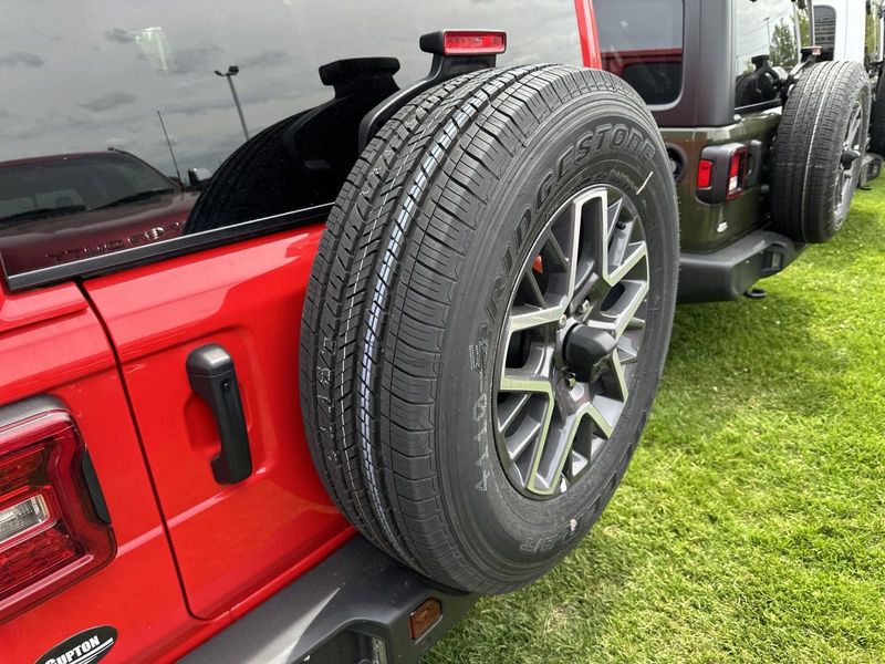 2024 Jeep Wrangler 4-door Sahara in a Firecracker Red Clear Coat exterior color. Gupton Motors Inc 615-384-2886 guptonmotors.com 