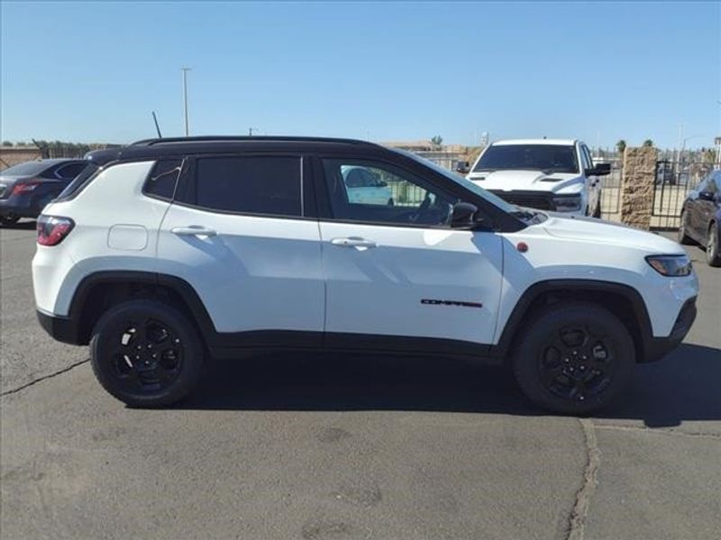 2024 Jeep Compass Trailhawk in a Bright White Clear Coat exterior color and Ruby Red/Blackinterior. Perris Valley Auto Center 951-657-6100 perrisvalleyautocenter.com 