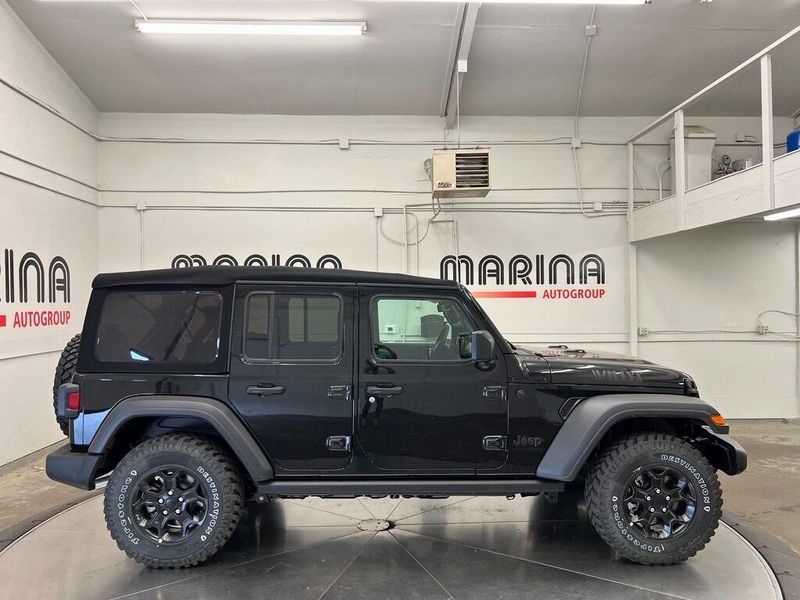 2023 Jeep Wrangler 4-door Willys 4x4 in a Black Clear Coat exterior color and Blackinterior. Marina Chrysler Dodge Jeep RAM (855) 616-8084 marinadodgeny.com 