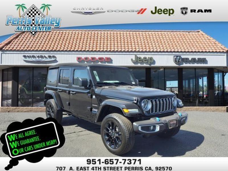 2024 Jeep Wrangler Sahara 4xe in a Black Clear Coat exterior color and Blackinterior. Perris Valley Auto Center 951-657-6100 perrisvalleyautocenter.com 