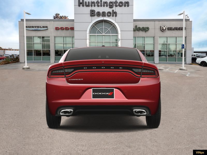 2023 Dodge Charger SXT in a Octane Red Pearl Coat exterior color and Blackinterior. BEACH BLVD OF CARS beachblvdofcars.com 