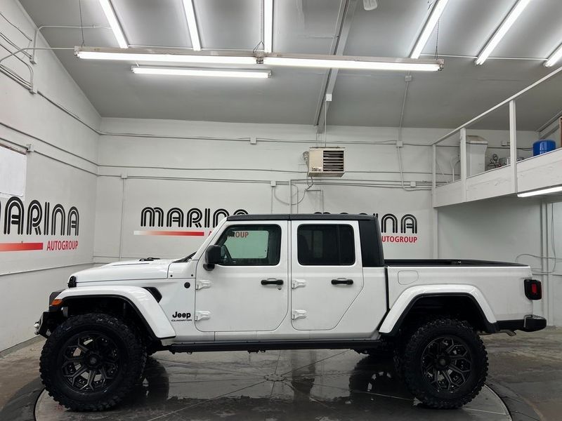 2022 Jeep Gladiator Sport S 4x4 in a Bright White Clear Coat exterior color and Global Black/Steel Grayinterior. Marina Auto Group (855) 564-8688 marinaautogroup.com 