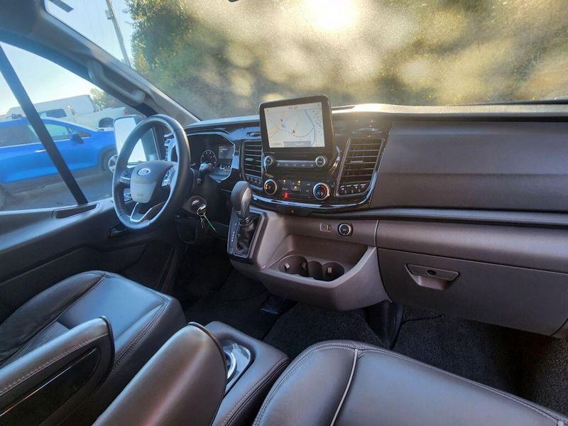 2021 Ford Transit-150 Cargo Van  in a Carbonized Gray Metallic exterior color and Graphiteinterior. Paul Sherry Chrysler Dodge Jeep RAM (937) 749-7061 sherrychrysler.net 