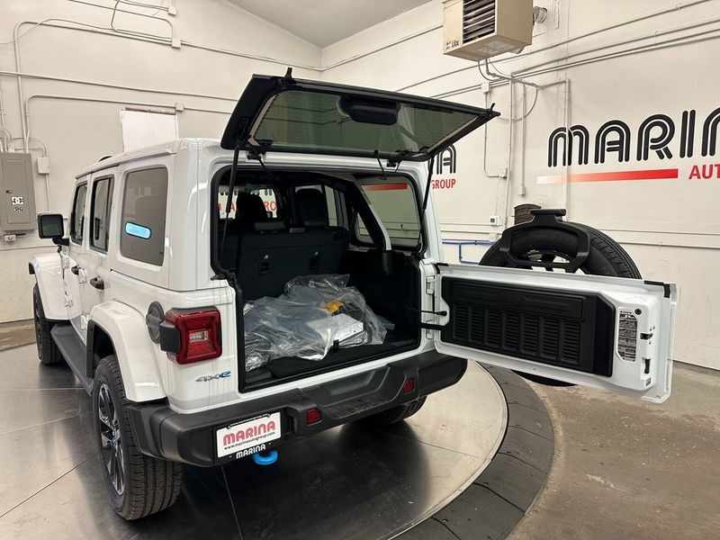 2024 Jeep Wrangler 4-door Sahara 4xe in a Bright White Clear Coat exterior color. Marina Auto Group (855) 564-8688 marinaautogroup.com 