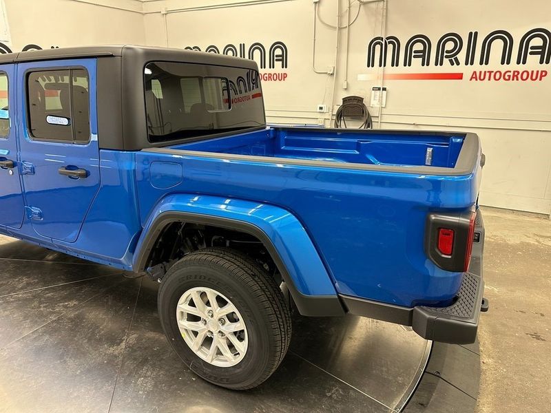 2023 Jeep Gladiator Sport S 4x4 in a Hydro Blue Pearl Coat exterior color and Blackinterior. Marina Auto Group (855) 564-8688 marinaautogroup.com 