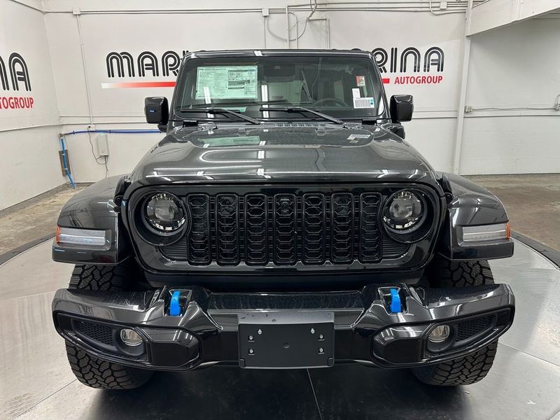 2024 Jeep Wrangler 4-door High Altitude 4xe in a Black Clear Coat exterior color and Green/Blackinterior. Marina Auto Group (855) 564-8688 marinaautogroup.com 