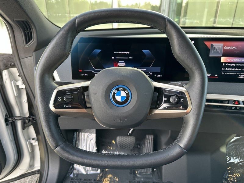 2023 BMW iX xDrive50 in a Alpine White exterior color and Blackinterior. SHELLY AUTOMOTIVE shellyautomotive.com 