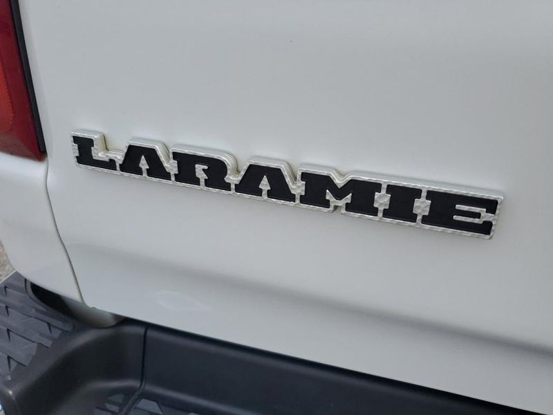 2020 RAM 1500 Laramie in a Bright White Clear Coat exterior color and Blackinterior. Johnson Dodge 601-693-6343 pixelmotiondemo.com 