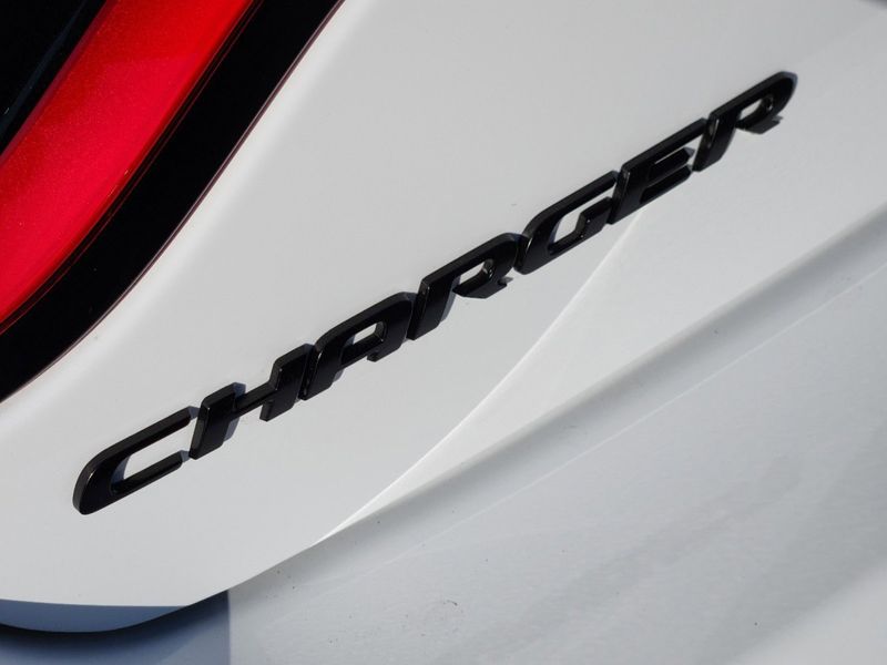 2023 Dodge Charger Scat Pack in a White Knuckle exterior color and Ruby Red/Blackinterior. Elder Chrysler Dodge Jeep Ram 9032920419 elderchryslerdodgejeep.com 