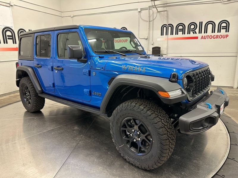 2024 Jeep Wrangler 4-door Willys 4xe in a Hydro Blue Pearl Coat exterior color and Blackinterior. Marina Chrysler Dodge Jeep RAM (855) 616-8084 marinadodgeny.com 