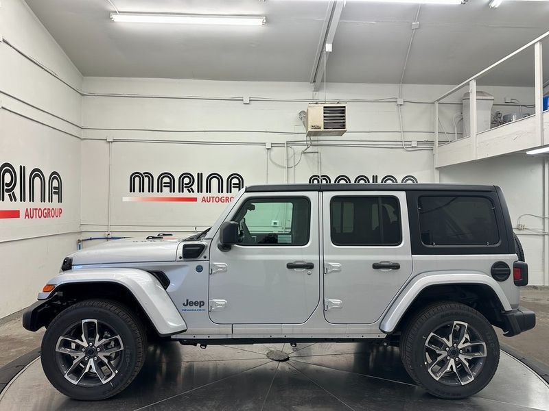 2024 Jeep Wrangler 4-door Sport S 4xe in a Silver Zynith Clear Coat exterior color and Blackinterior. Marina Chrysler Dodge Jeep RAM (855) 616-8084 marinadodgeny.com 