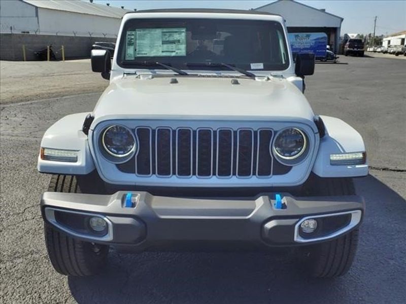 2024 Jeep Wrangler Sahara 4xe in a Bright White Clear Coat exterior color and Blackinterior. Perris Valley Auto Center 951-657-6100 perrisvalleyautocenter.com 