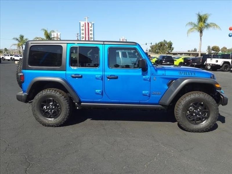 2024 Jeep Wrangler 4-door Willys 4xe in a Hydro Blue Pearl Coat exterior color and Blackinterior. Perris Valley Chrysler Dodge Jeep Ram 951-355-1970 perrisvalleydodgejeepchrysler.com 