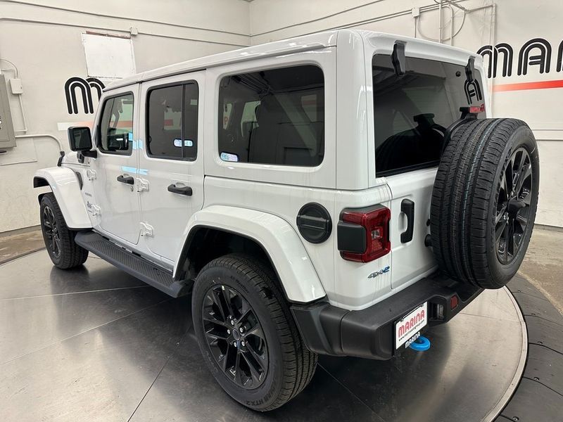 2024 Jeep Wrangler 4-door Sahara 4xe in a Bright White Clear Coat exterior color. Marina Auto Group (855) 564-8688 marinaautogroup.com 