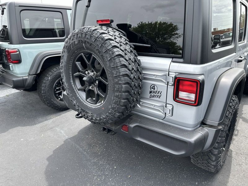 2024 Jeep Wrangler 4-door Willys in a Silver Zynith Clear Coat exterior color and Blackinterior. CDJR of Anytown 949-555-4321 pixelmotiondemo.com 