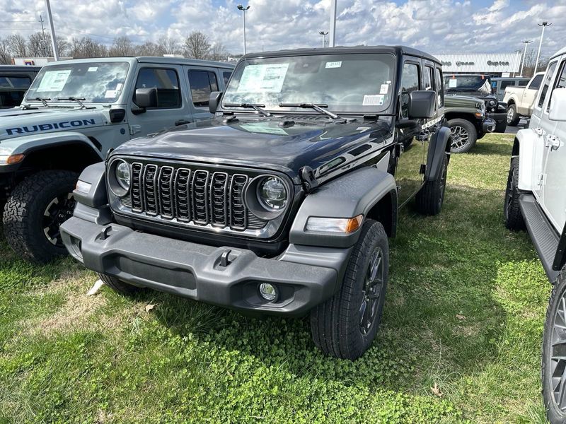 2024 Jeep Wrangler 4-door Sport S in a Black Clear Coat exterior color and Blackinterior. CDJR of Anytown 949-555-4321 pixelmotiondemo.com 