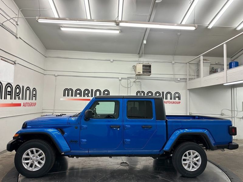 2023 Jeep Gladiator Sport S 4x4 in a Hydro Blue Pearl Coat exterior color and Blackinterior. Marina Auto Group (855) 564-8688 marinaautogroup.com 