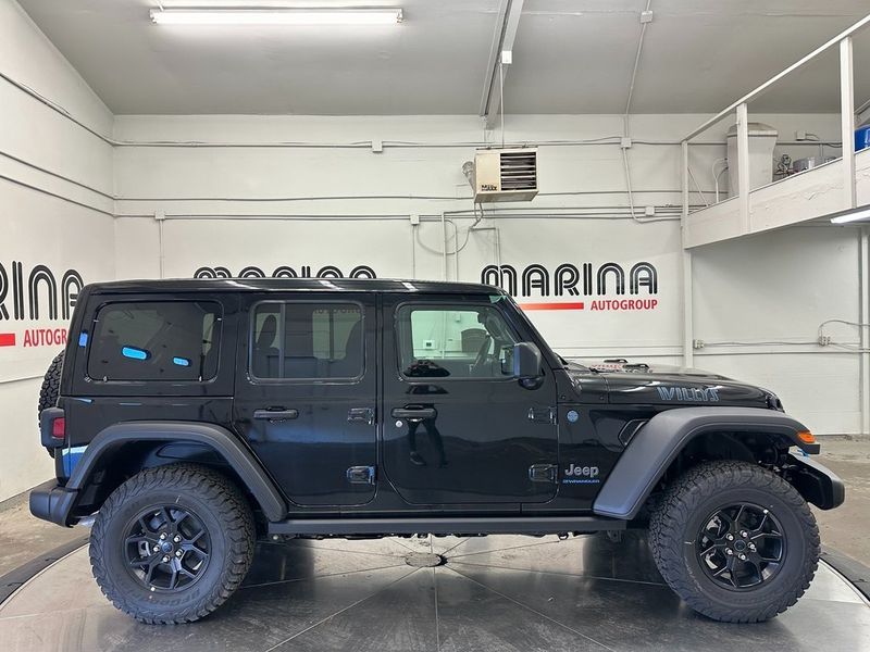 2024 Jeep Wrangler 4-door Willys 4xe in a Black Clear Coat exterior color and Blackinterior. Marina Auto Group (855) 564-8688 marinaautogroup.com 