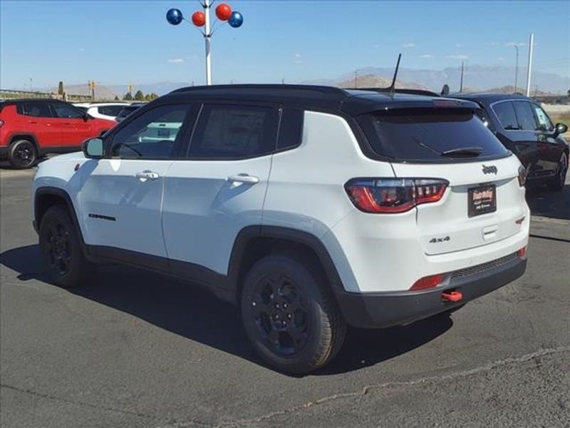 2024 Jeep Compass Trailhawk in a Bright White Clear Coat exterior color and Ruby Red/Blackinterior. Perris Valley Auto Center 951-657-6100 perrisvalleyautocenter.com 