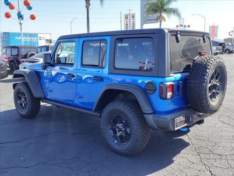 2024 Jeep Wrangler Willys 4xe in a Hydro Blue Pearl Coat exterior color and Blackinterior. Perris Valley Auto Center 951-657-6100 perrisvalleyautocenter.com 
