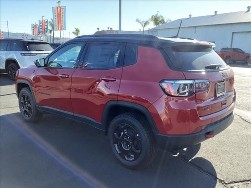 2024 Jeep Compass Trailhawk in a Prm exterior color and Ruby Red/Blackinterior. Perris Valley Auto Center 951-657-6100 perrisvalleyautocenter.com 