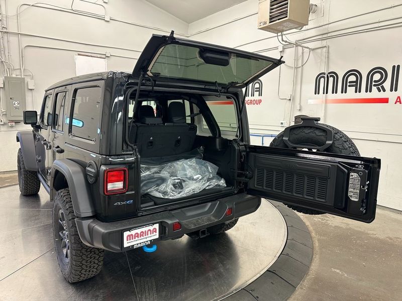 2024 Jeep Wrangler 4-door Willys 4xe in a Black Clear Coat exterior color and Blackinterior. Marina Auto Group (855) 564-8688 marinaautogroup.com 