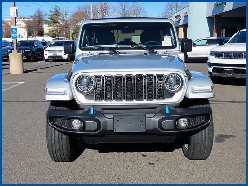 2024 Jeep Wrangler 4xE Sport S 4xe in a Silver Zynith Clear Coat exterior color and Blackinterior. Papas Jeep Ram In New Britain, CT 860-356-0523 papasjeepram.com 